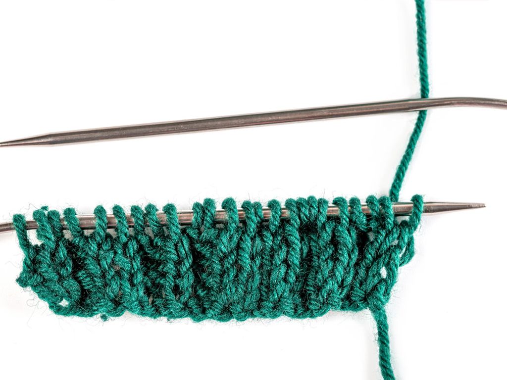 Knitting needles and yarn. 
