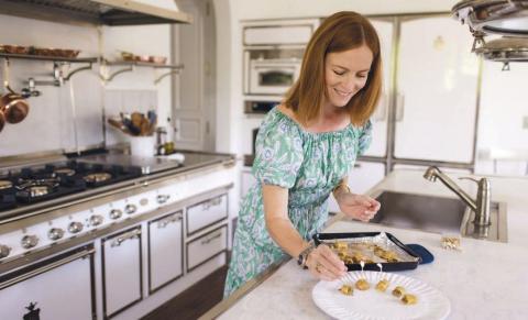 Caryn Antonini cooking in a white kitchen