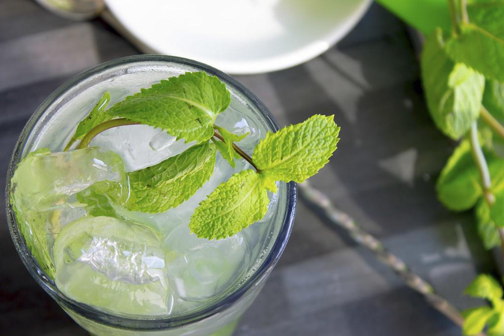 Mojito cocktail topped with mint leaves